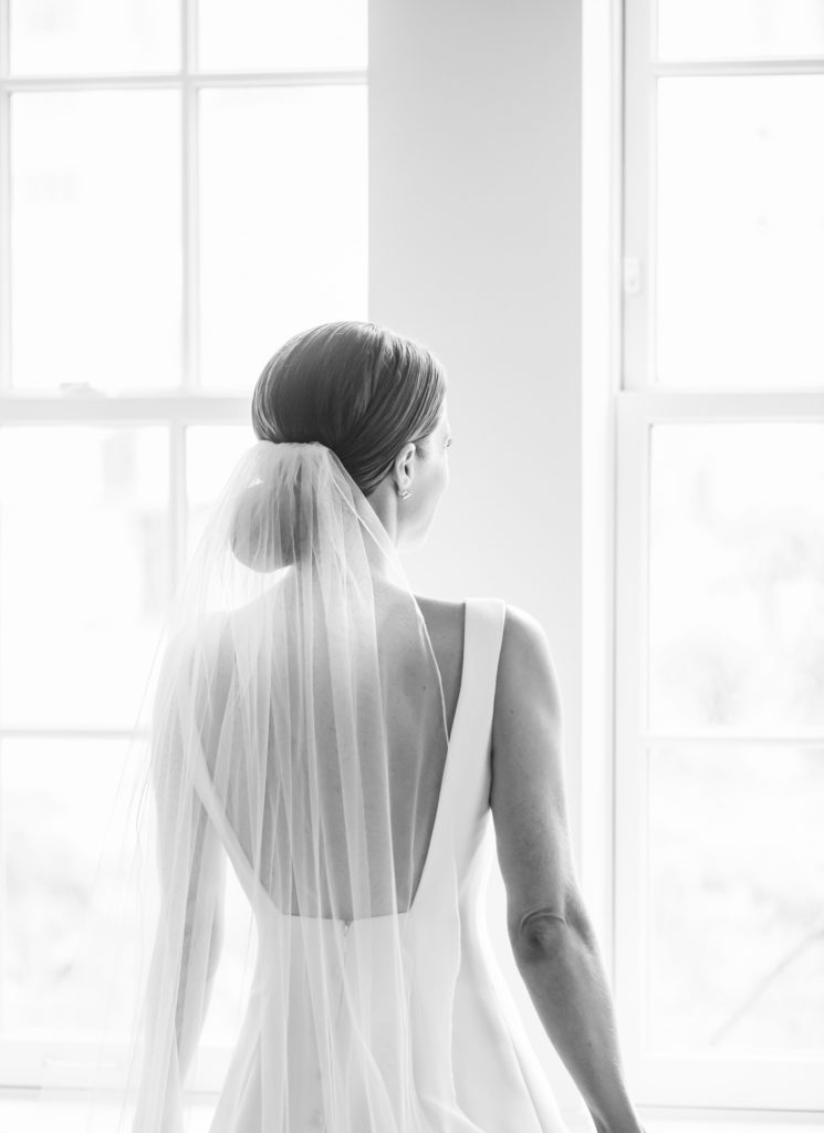 Bride looking out Mark Hotel window