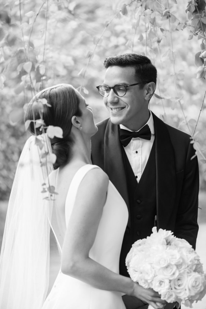 wedding day couple smile at one another