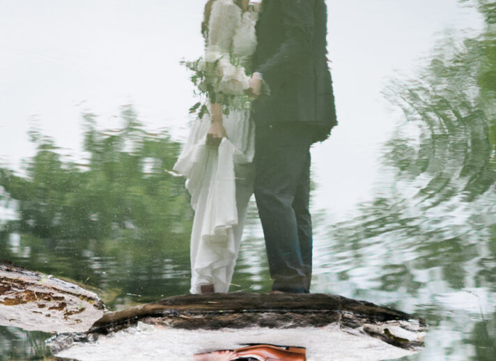 reflection in water of a couple kissing